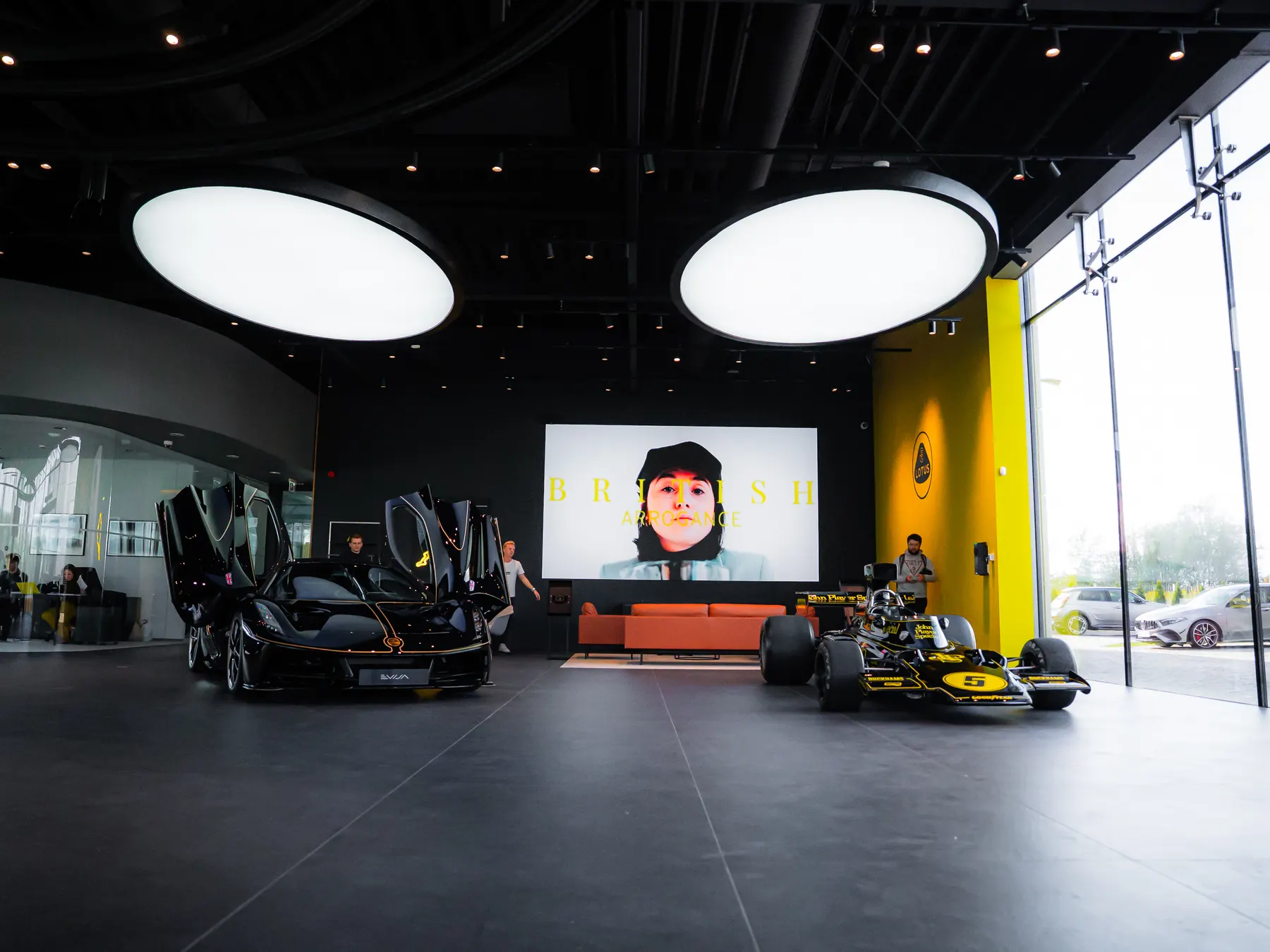 The Evija Fittipaldi and the Lotus Type 72 racing car side by side in the Lotus Warszawa showroom